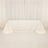 White tablecloth draped over a table in a studio setting.