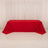 Red tablecloth draped over a table in a studio setting.
