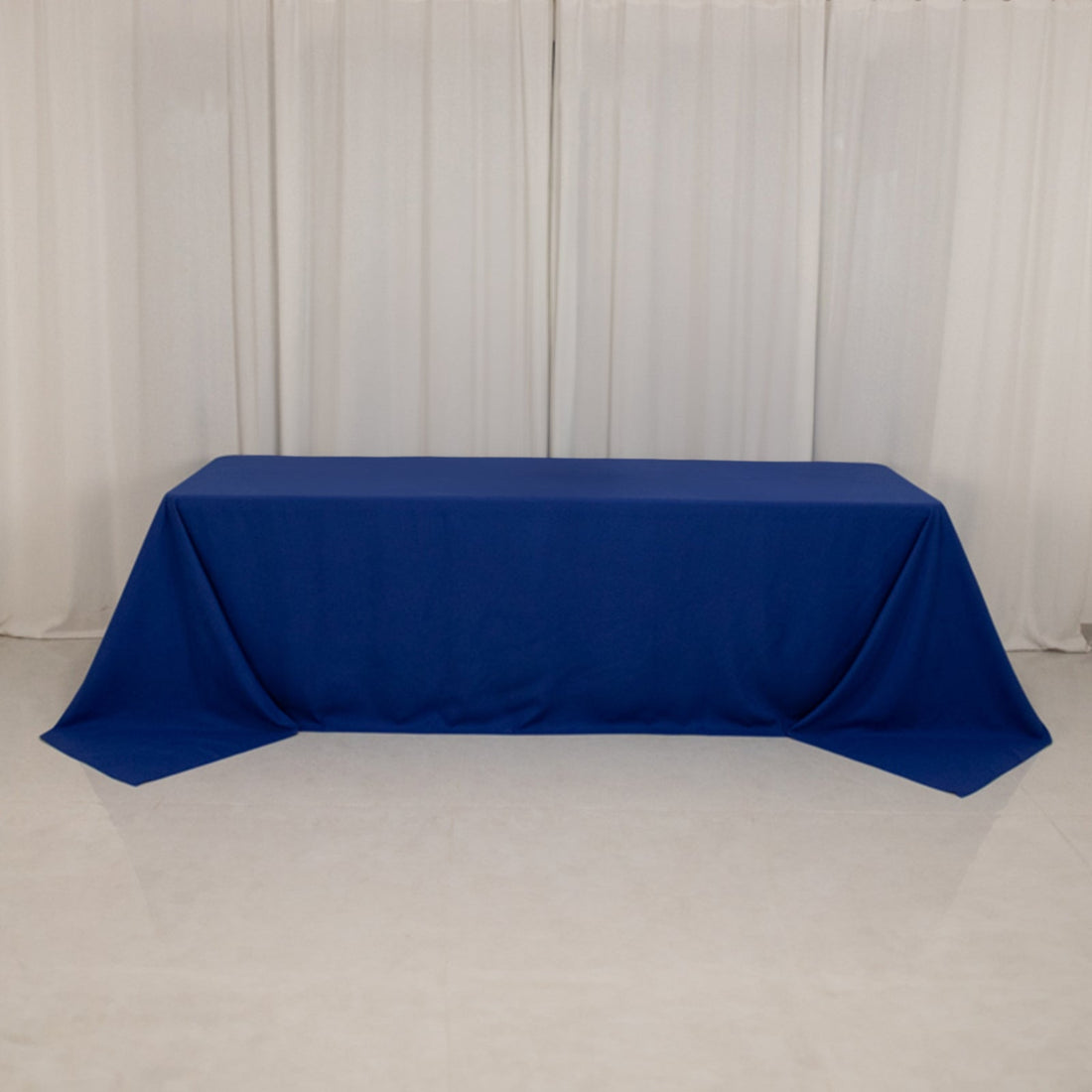 Blue tablecloth draped over a table with a smooth finish