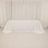 White tablecloth draped over table in a studio setting.