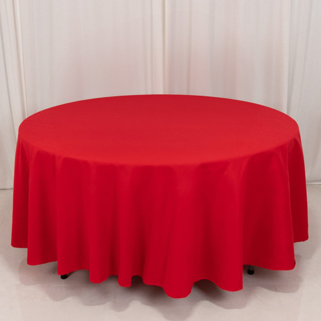 Red round tablecloth draped elegantly on a table.