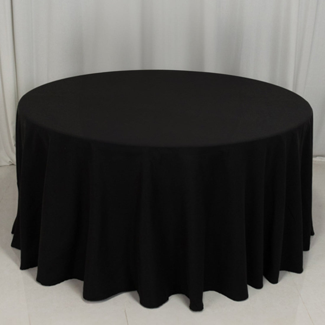 Black round tablecloth with elegant draping for formal events and dining.