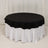 Black round tablecloth on a white table with ruffled edges.
