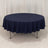Navy round tablecloth draped on a table with a seamless backdrop.
