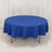 Round blue tablecloth on a table with a plain backdrop.