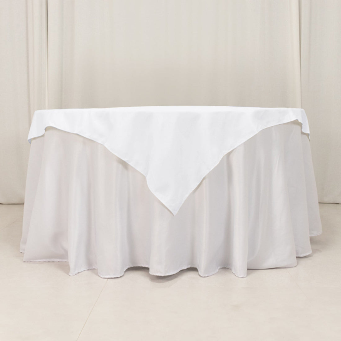 White tablecloth with elegant draping and a triangular corner design.