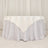 Elegant white tablecloth draping over a round table.