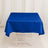 Blue tablecloth on a white table against a plain backdrop.