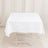 White tablecloth draped over a table in a studio setting.