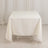 White tablecloth draped over a table in a studio setting.