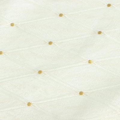 Cream quilted fabric with gold dot pattern close-up#whtbkgd