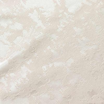 Cream textured floral fabric pattern close-up
