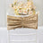 Gold chair sash with pleated design, styled for elegant decor.