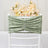 Green velvet chair cover with gathered detail against a floral backdrop.