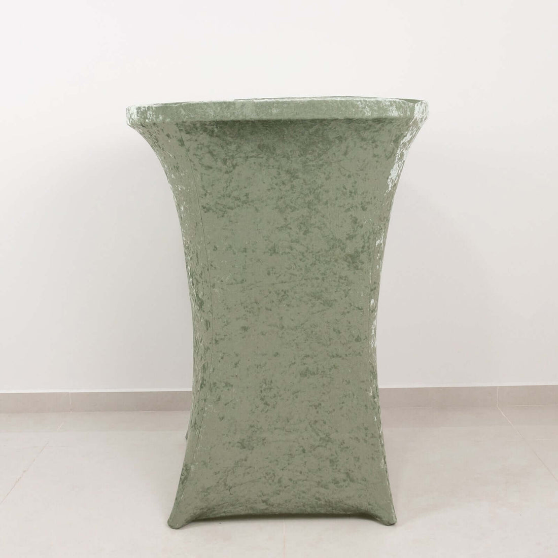 Green velvet table cover in studio isolation