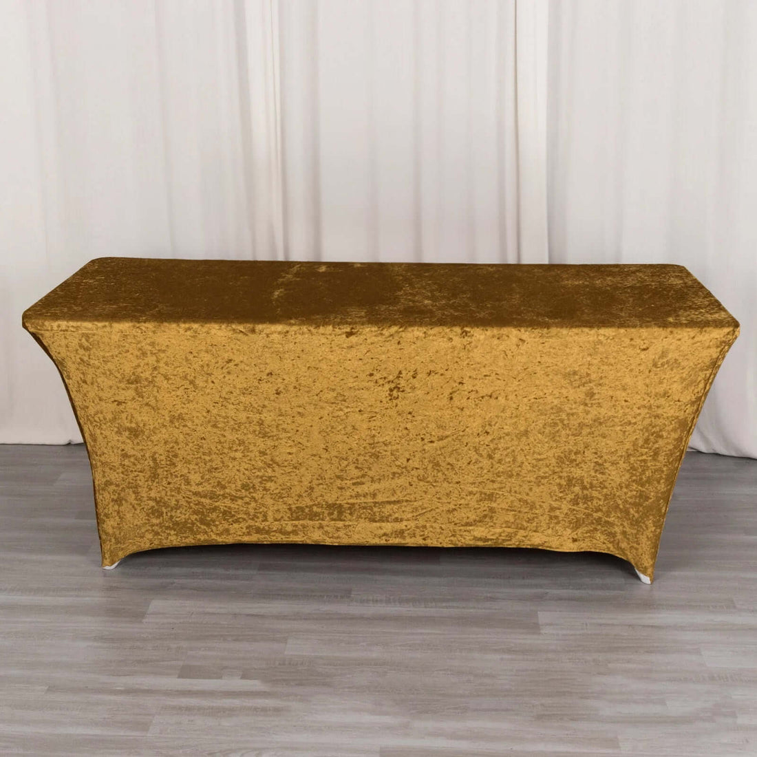 Gold tablecloth draped over a rectangular table in a studio setting.