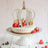 Elegant cake topped with a sparkling crown and fresh berries.