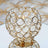 Gold crystal candle holder with decorative design and reflective base.