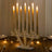 Elegant crystal candle holder with six lit candles on a wooden table.