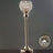 Elegant crystal candle holder with gold finish and intricate design.