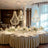 Elegant chandelier trio hanging above a beautifully set dining table.