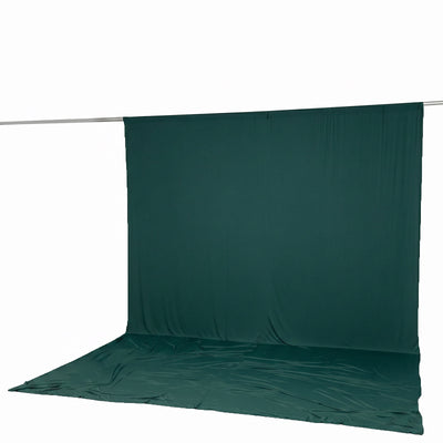 Dark green photography backdrop with floor sweep on hanging rod