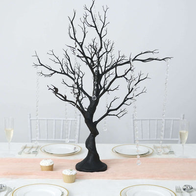 Black decorative tree centerpiece with crystal accents for elegant dining.