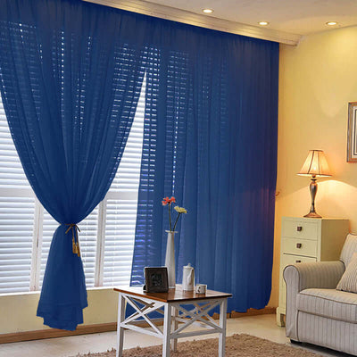 Blue sheer curtains elegantly draping a window in a cozy living room setting.