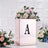 Rose gold box with floral arrangement and letter "A" on a textured background.