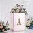 Elegant floral arrangement in a mirrored box with letter 'A' decoration.