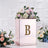 Elegant floral arrangement in a mirrored box with letter "B" detail.