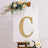 Decorative letter "C" with lights and flowers on a display board.