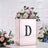 Decorative floral arrangement in a stylish rose gold box with a letter "D".