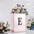 Mirrored floral arrangement box with letter "E" and decorative flowers.