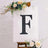 Decorative letter "F" on a floral backdrop.
