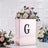 Elegant floral arrangement in a rose gold box with a "G" monogram.
