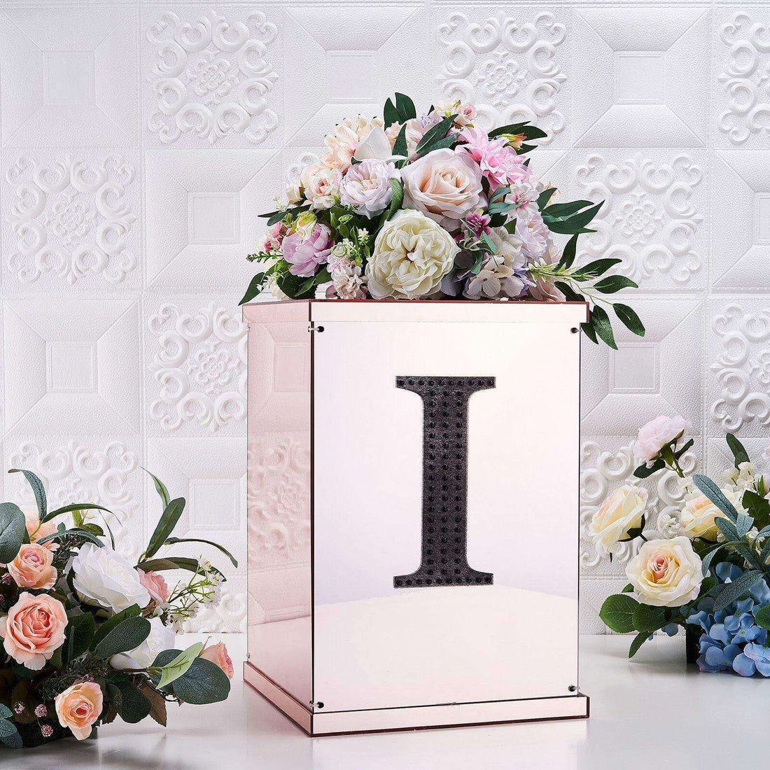 Decorative floral arrangement in a mirrored box with an 'I' design.