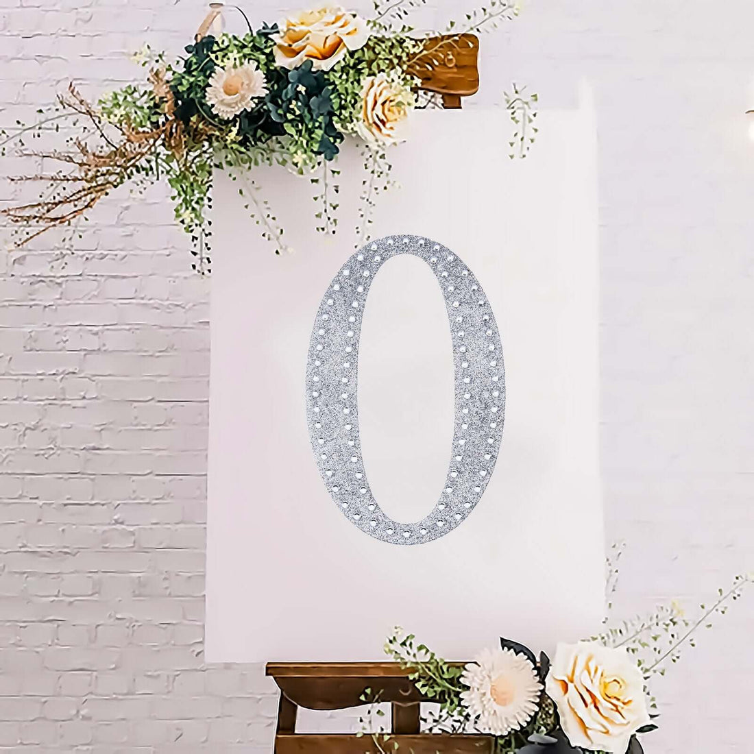 Decorative floral number "0" on a white canvas backdrop.