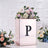 Decorative box with floral arrangement and letter "P" on a textured background.