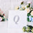 Silver rhinestone letter Q on a white square card with floral background.