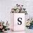 Floral arrangement in a decorative box with an "S" design.