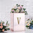 Elegant floral arrangement in a decorative box with a gold letter V.