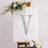 Decorative letter "V" on a canvas with floral accents.