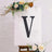 Black letter "V" on a white canvas with floral accents.