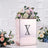 Rose gold floral display box with decorative letter X and flowers.