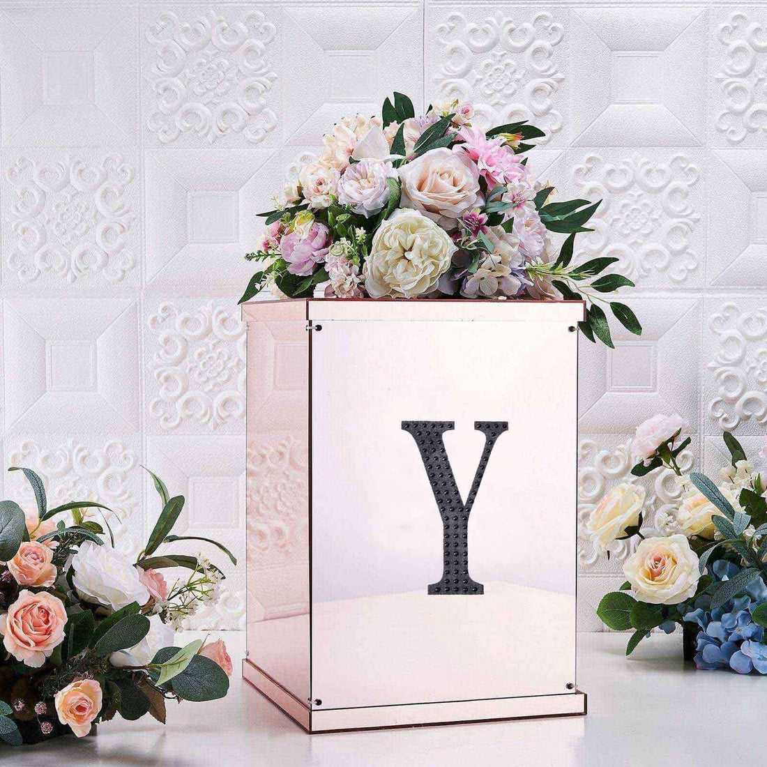 Decorative rose gold box with a floral arrangement and letter "Y" accent.