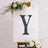 Decorative letter "Y" on an easel with floral accents.