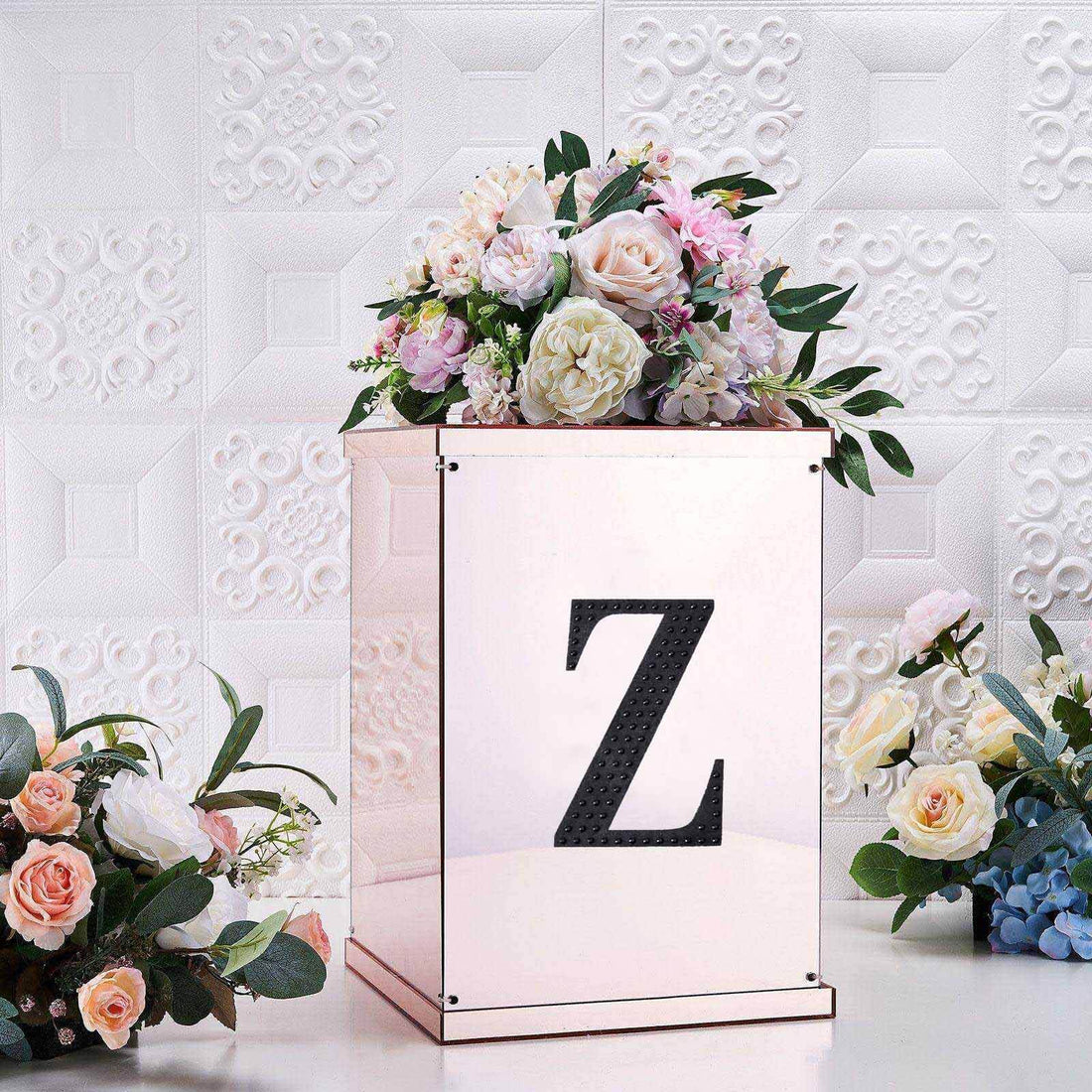 Floral arrangement in a decorative box with a letter "Z" on a textured background.
