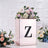 Floral arrangement in a decorative box with a letter "Z" on a textured background.