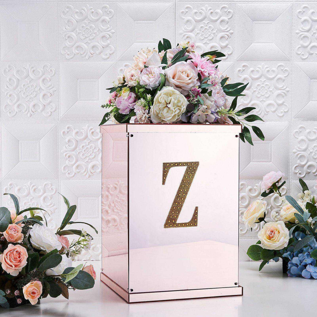 Decorative floral arrangement in a mirrored box with a gold letter Z.
